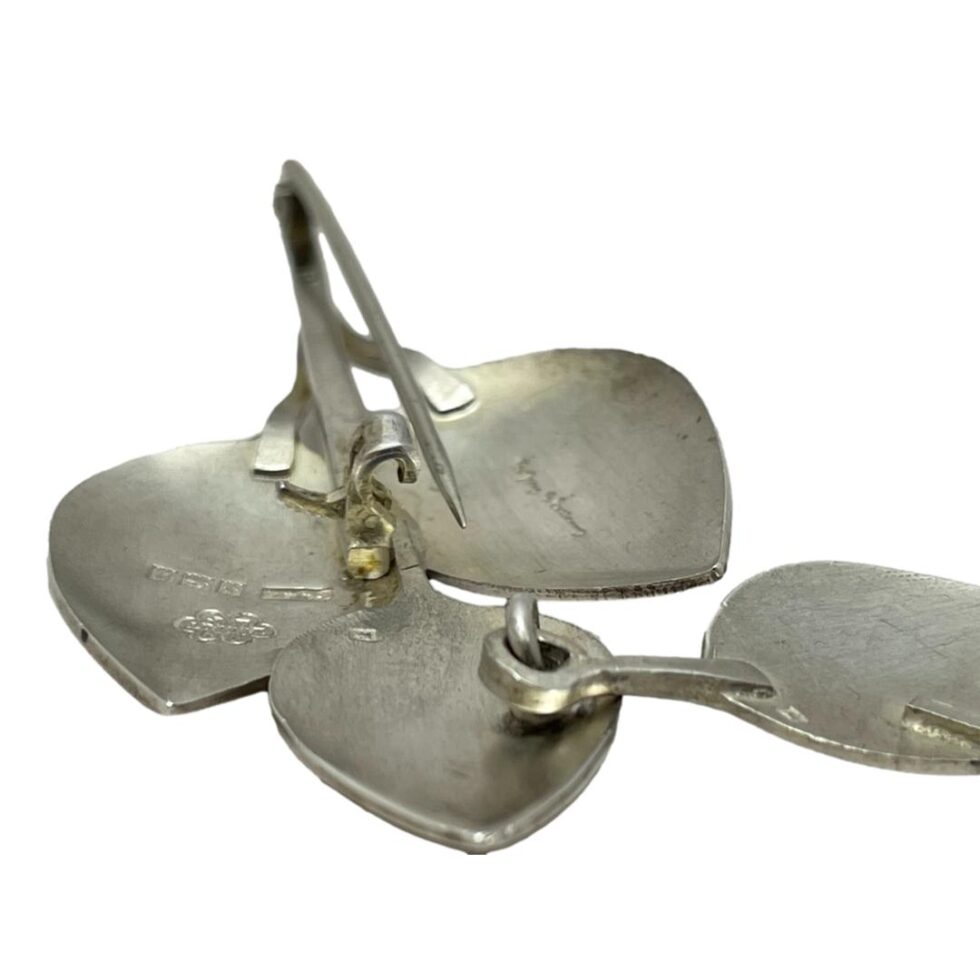 Close up photo of the pin area seen from pin end to show the special click shut clasp. Pin is shown undone and clasp open.