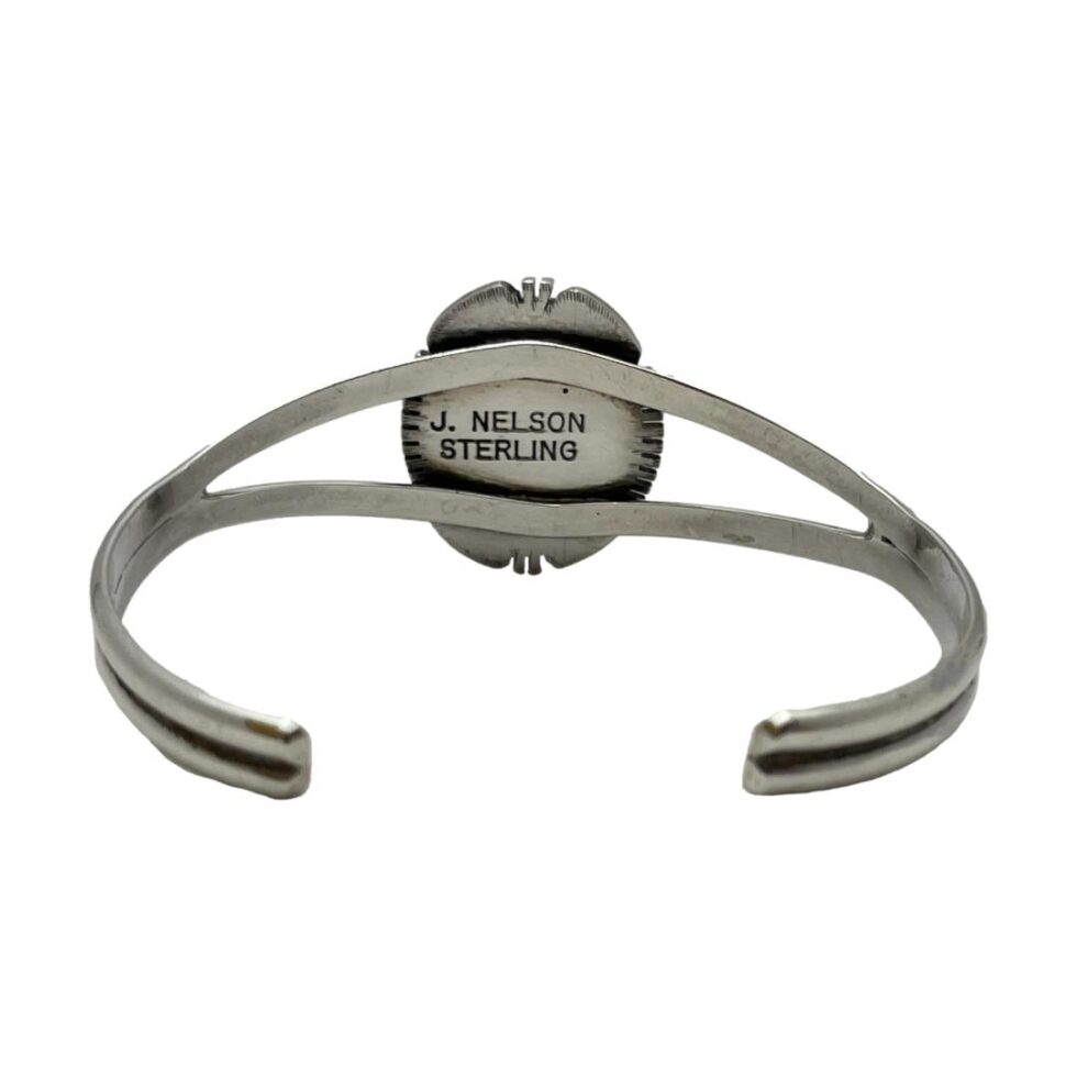 Photo of the back of the bracelet showing the signature and hallmark on the back of shell area.