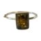 Main photo of Modernist Czech amber bracelet seen with the large amber in the centre foreground. The bracelet, which has quite a thin band in comparison to the large amber has a hinge and hook clasp which makes the bracelet resemble a bangle. The clasp area is just visible to the left.