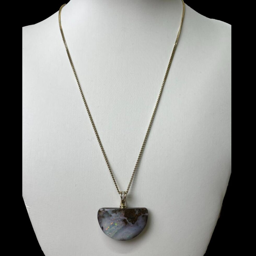 Photo of opal diamond pendant &chain displayed on a necklace display stand with the pendant front forward facing.