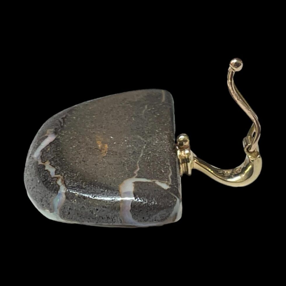 Photo of pendant only displayed face down with the bail to the right and shown open. The clip shut design is visible here with the ball clip at base.