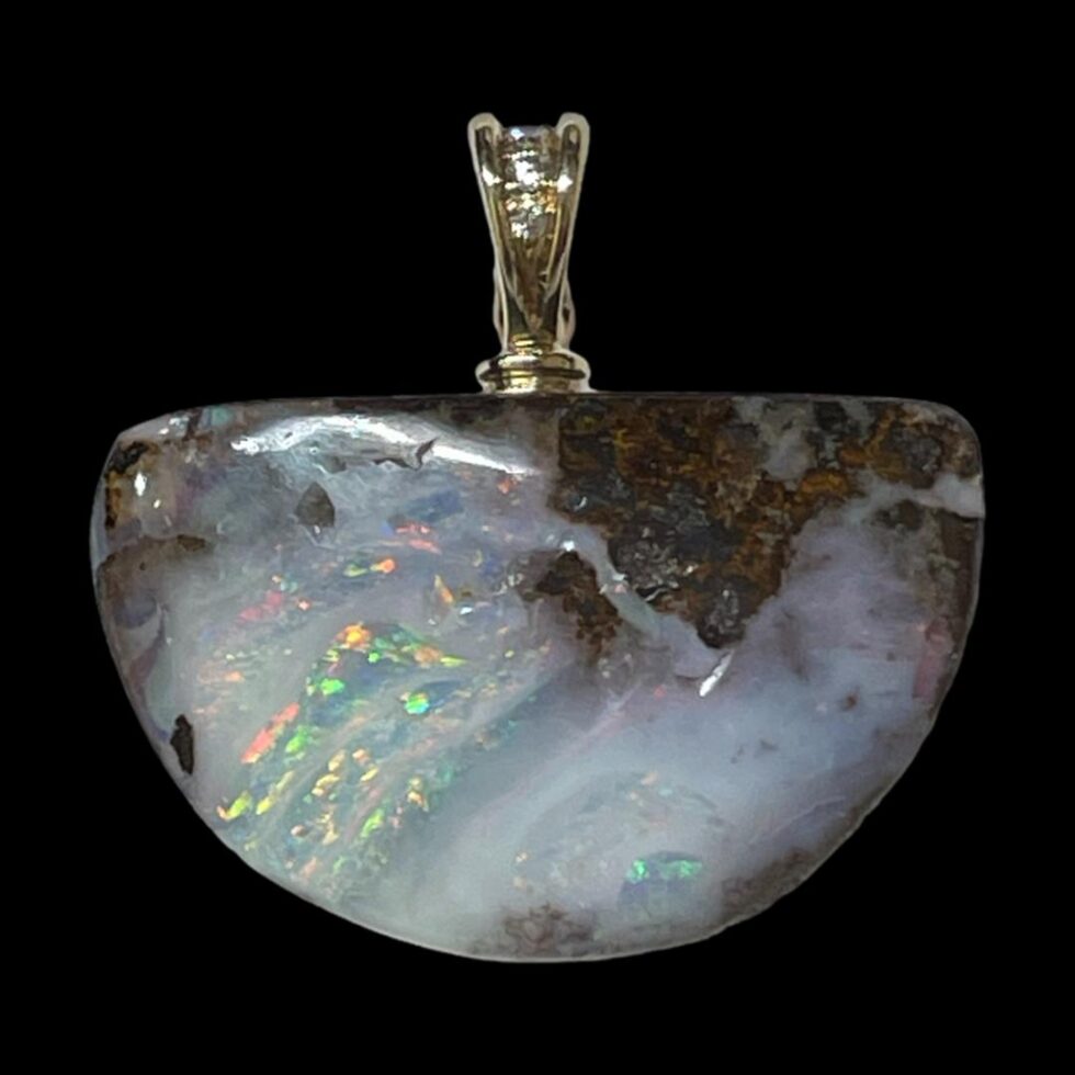 Photo of the boulder opal only seen with bail in top centre as it would be when worn. The diamonds are visible in the bail.