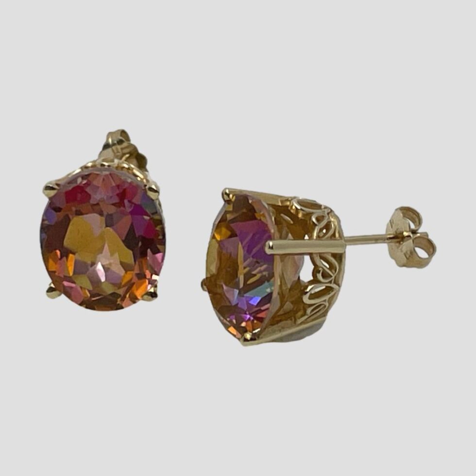 Photo of mystic topaz studs with one on left forward facing and right one side view showing the intricate gold setting for the stone. The front of stud is set prominently forward.