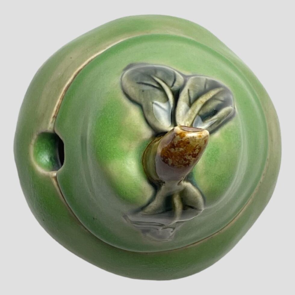 Photo of preserve pot looking straight down from above. The gap where a spoon will sit is visible to the left, it is a small round hole with gap on bottom half of pot slightly bigger than on lid.