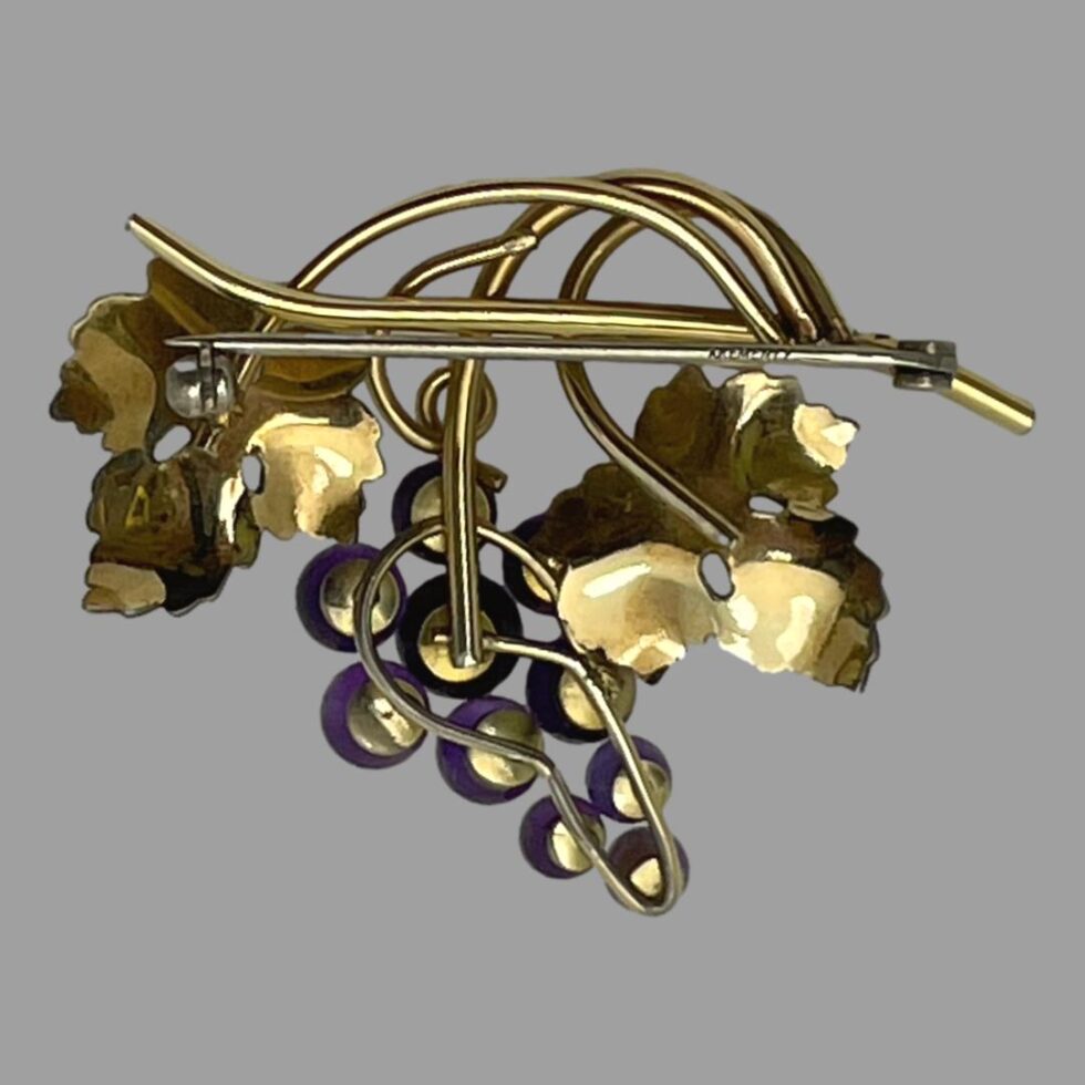 Photo of the back of brooch displayed with pin closed.