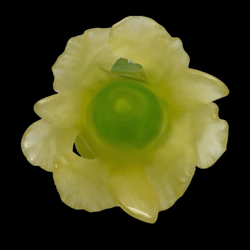 Photo looking straight down into the Daum Art Nouveau vase from above. The pale yellow of the orchids around the green circle at base.