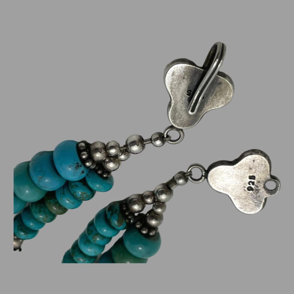 Close up photo of the back of the floral shaped clasps. Both sides have 925 hallmark for sterling silver. Hook closure.