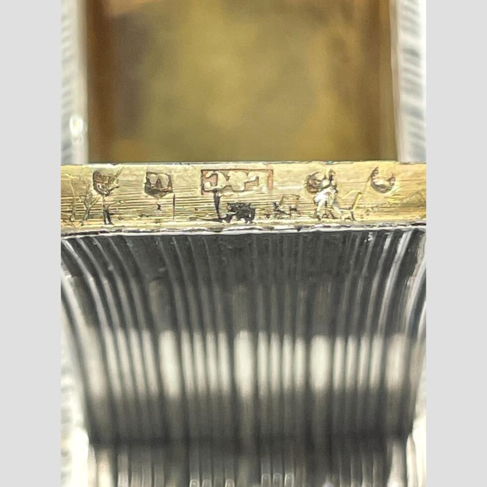 Close up photo of the hallmark on the edge of inside lid.