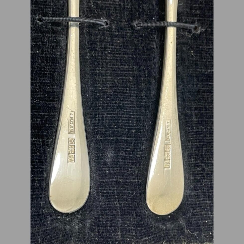 Close up photo of the full hallmark to each butter knife handle.