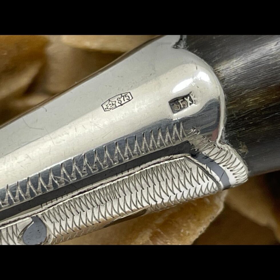 A close up photo of the hallmark stamps on the neck of the bird.