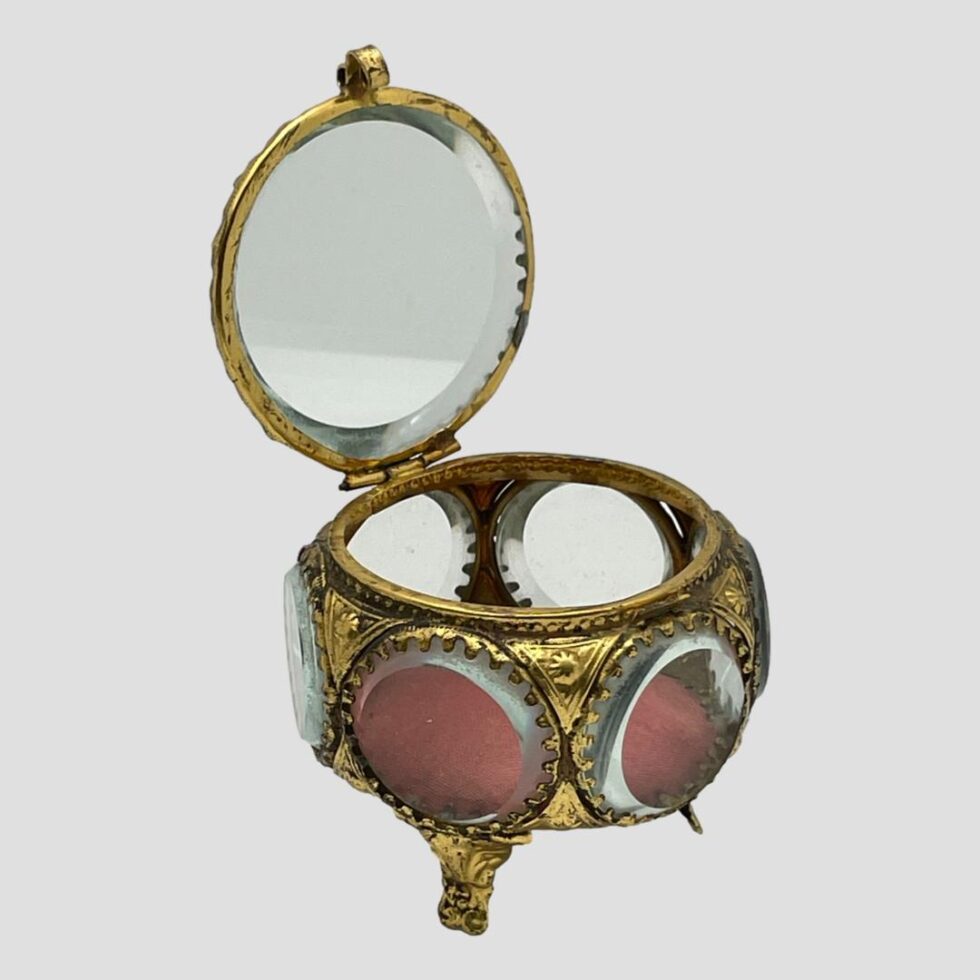 Photo of French bijouterie box displayed with the lid open on its hinge and upright.