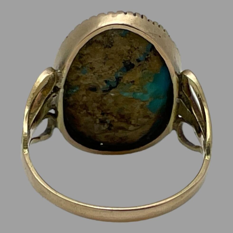 Photo of the back of the antique gold turquoise ring this time seen from the back showing the stone setting.