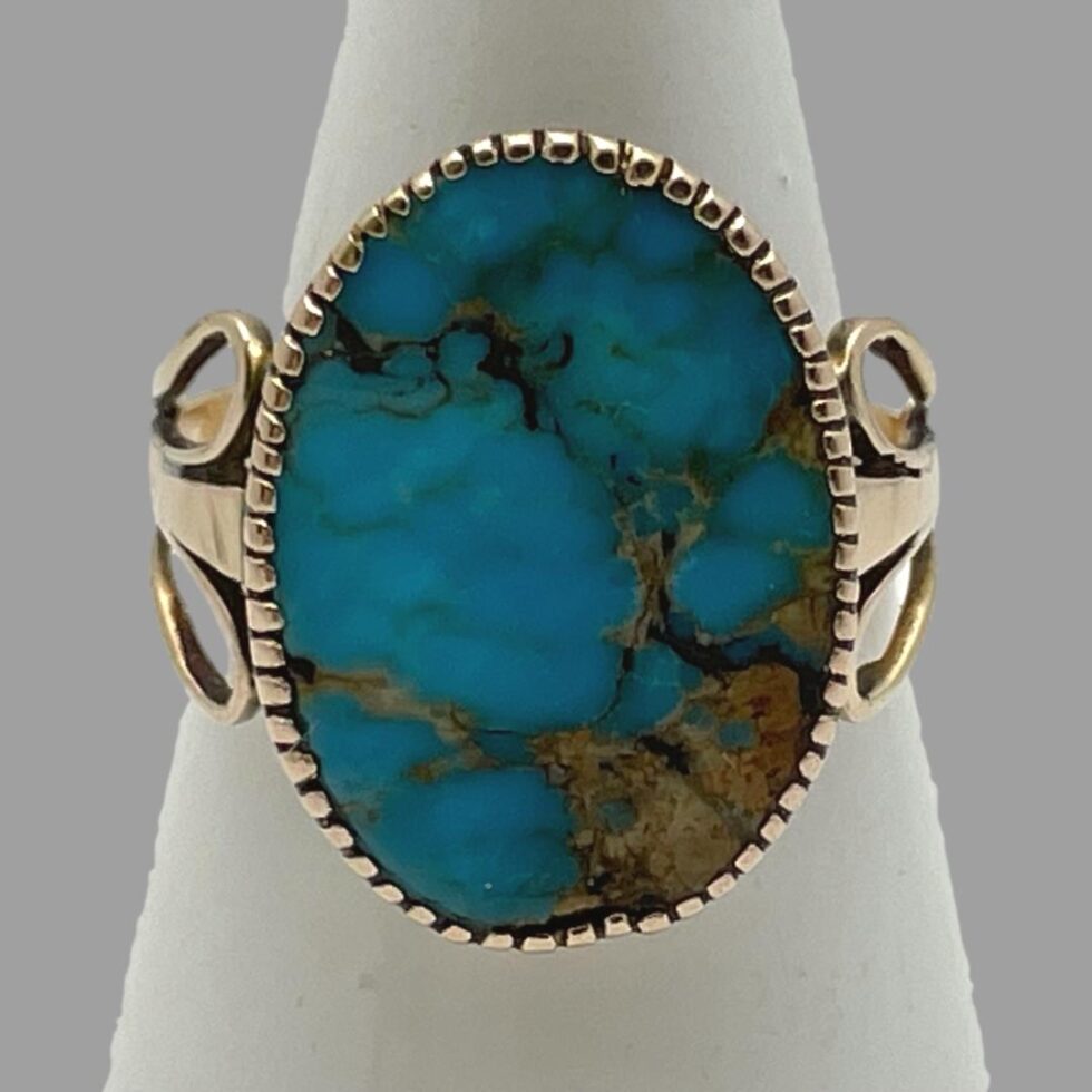 Photo of ring displayed on a cone shaped stand with the ring front shown in forward facing close up.