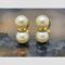 Main photo of gold & pearl clip-ons displayed on top of a slice of natural agate with the earring fronts forward facing. The pearls are set one above the other with a gold divider. A little like a figure of eight with an elongated mid section...in gold! These earrings look stunning when worn.