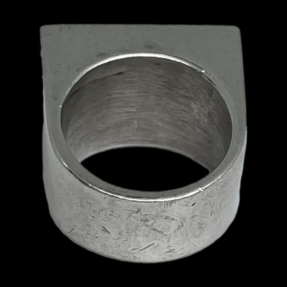 Photo of the back of Modernist Brutalist silver ring seen from the back band. At this angle the ring could be a piece of industrial equipment! Thich chunky lump of silver it is!