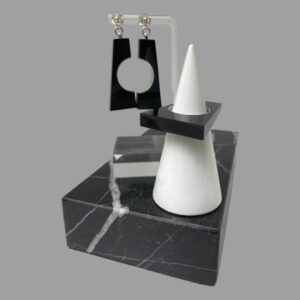 Main photo of 60s style earrings and ring set displayed together with the ring on a cone shaped white stand which is on top of a block of black marble. To the back left, the earrings are hanging from a Perspex stand. The earrings, when put together are the exact same size and shape as the ring. Imagine a pyramid with the pointed top lopped off and a circle in the centre which is then cut in half. That is the earrings. The ring is obviously not cut in half! The earrings have silver posts and lined with silver on the inside of the semi circles. The ring has just the silver lining on the inside of circle. Hallmarked to all 3 pieces.