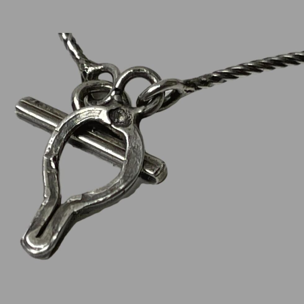 Close up photo of the clasp area showing the crab hallmark on the ring of the toggle and ring clasp.