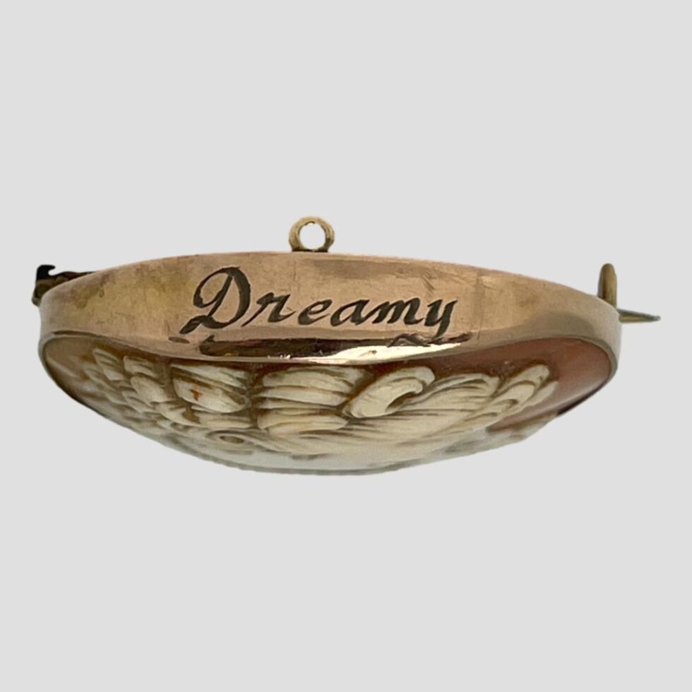 Photo of the 'Dreamy' beautifully engraved to the top of the of the cameo on the gold.
