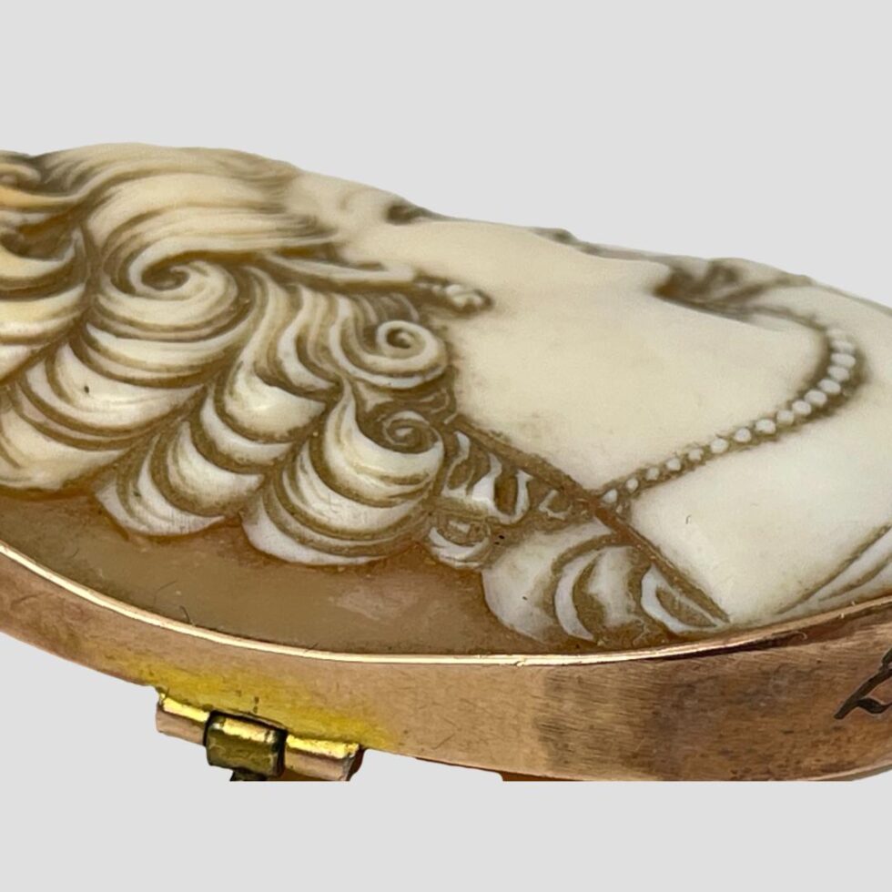 Photo of cameo from a side angle to show the carving detail of the ladies hair.