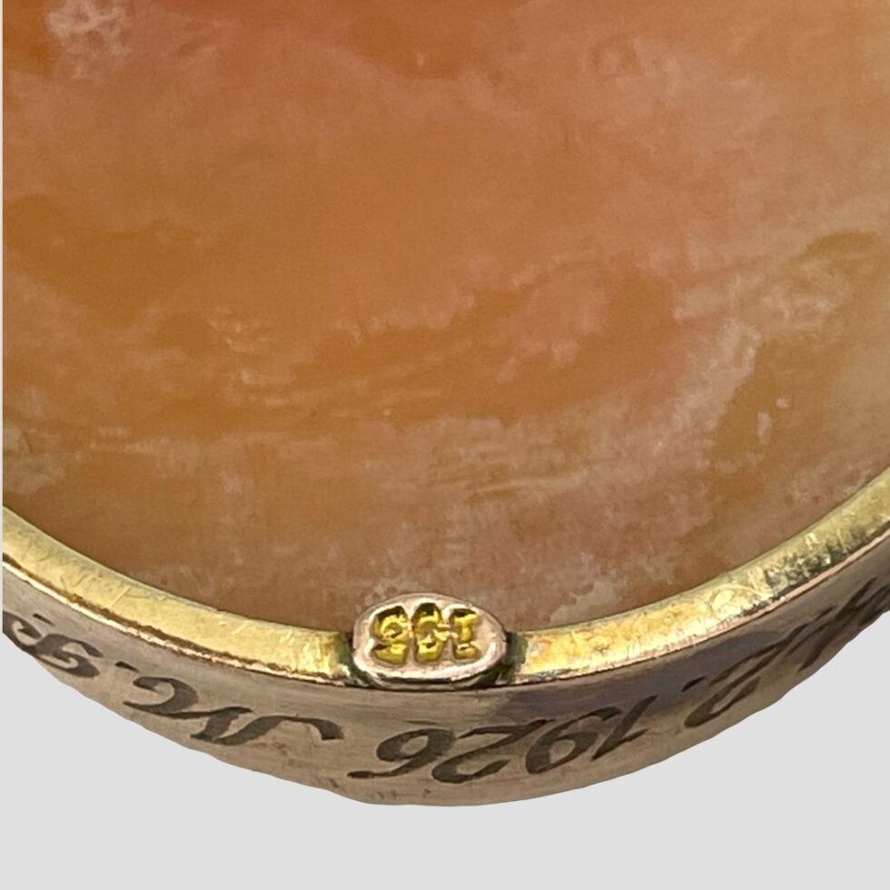 Close up photo of the 9ct hallmark which is on its own little tab at the bottom part of the cameo at the back.