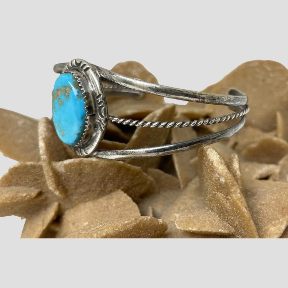 Photo of cuff bracelet this time seen with the turquoise front facing left.