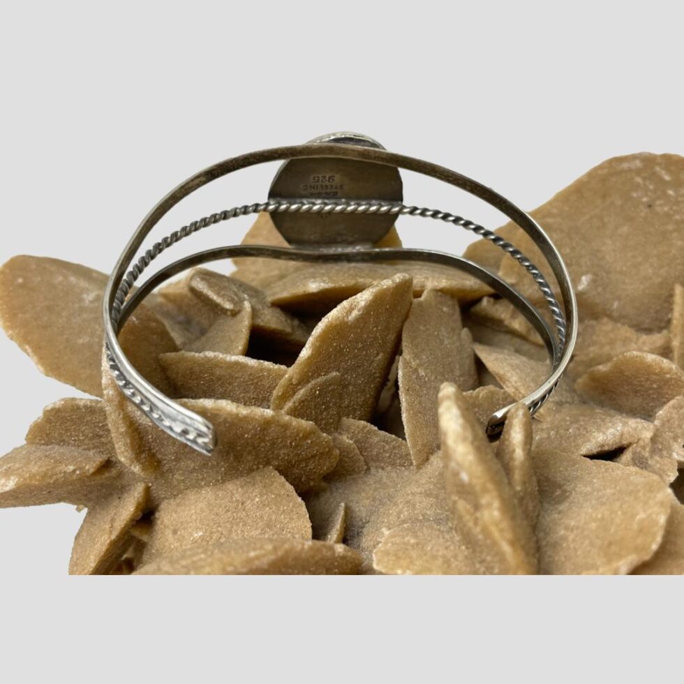 Photo of cuff bracelet displayed from the back showing the smoothed off ends of the triple banded cuff.