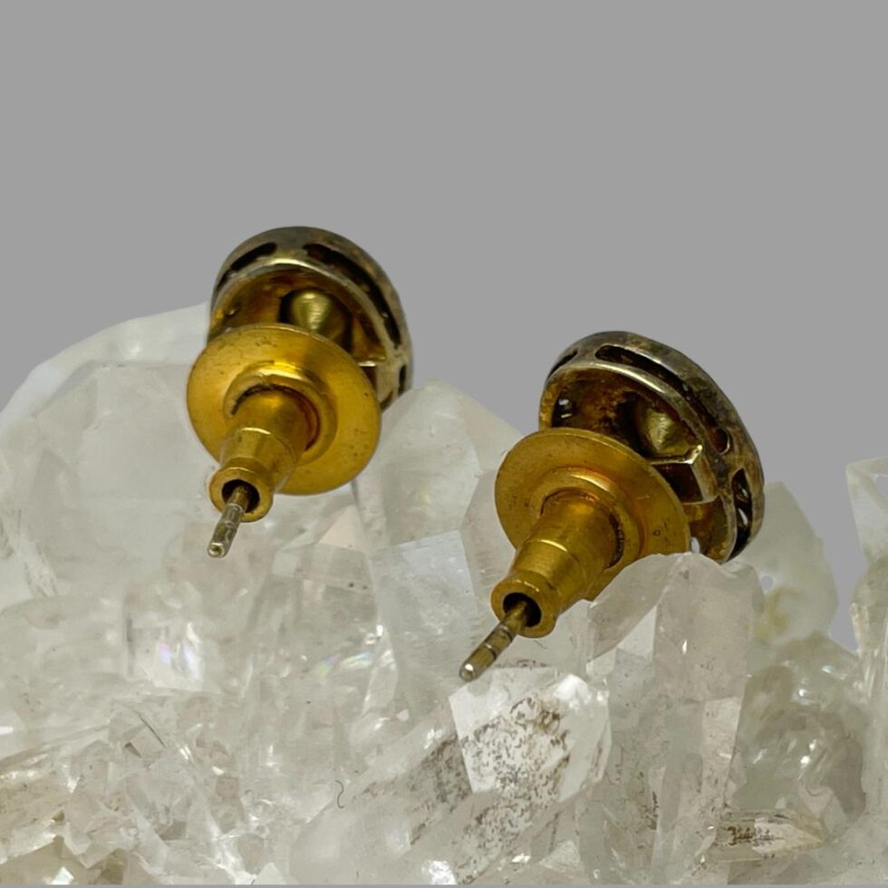 Photo of the backs of both rose cut diamond studs showing the butterfly fasteners which have a flat edge to sit against the ear lobe securely.