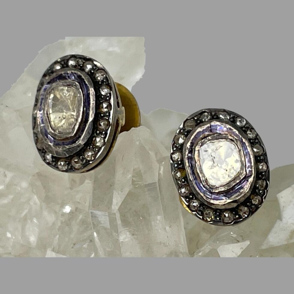 Close up photo of the rose cut diamond studs. One on right is forward facing and left one is facing slightly to the left. The rose cut diamonds give an incredible sparkle and the blue enamel accentuates this.