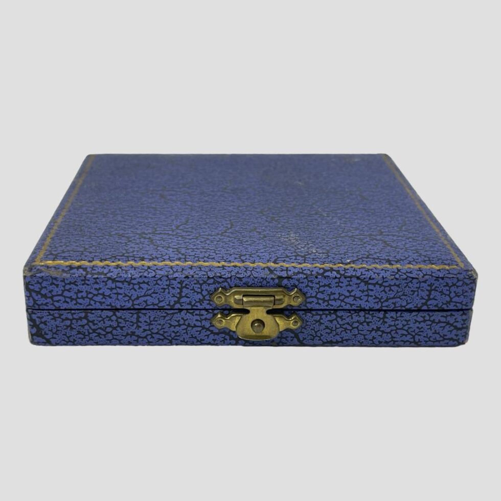 Photo of the closed case which is blue and showing very minimal signs of wear. Clasp in good order.