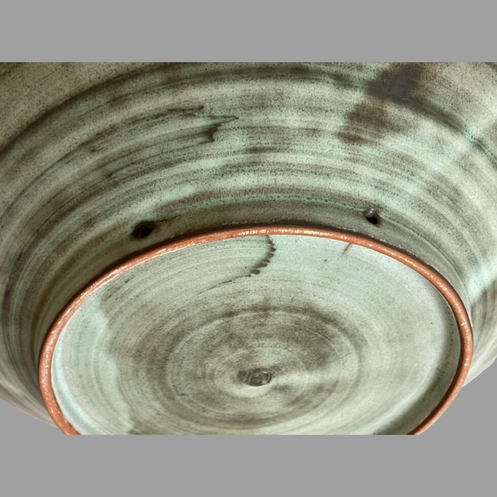 Photo looking down at the 2 holes used for threading rope to hang the bowl as a wall decoration.