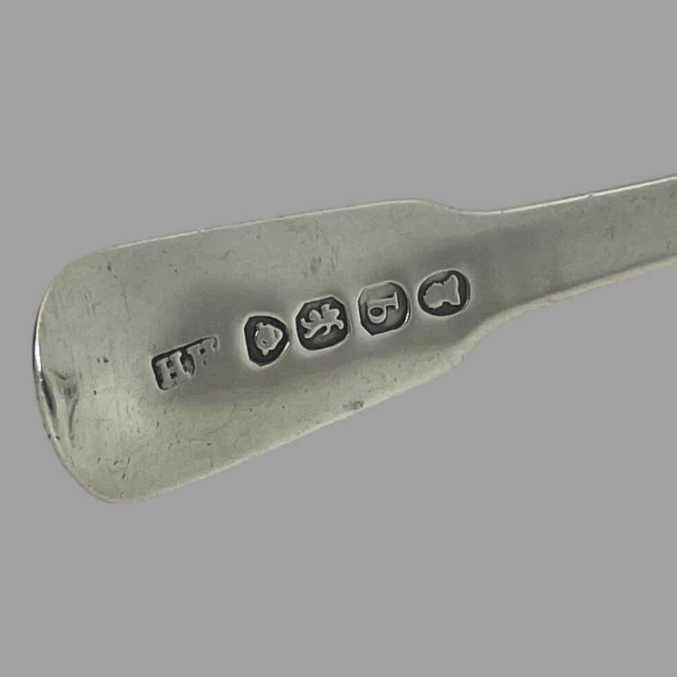 Close up photo of the full hallmark to the back of spoon handle tip.