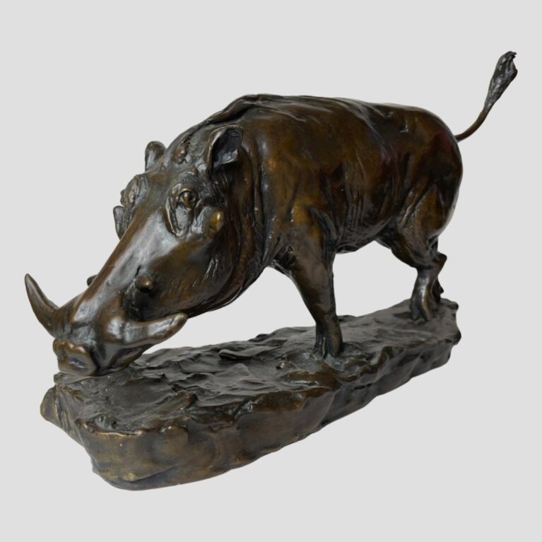 Main photo of Harriet Glen bronze boar displayed with the boar posed diagonally across the page with its head in the bottom left foreground and tail upright in the top right background. The boar has a long face with healthy looking tusks and appears in mid trot perhaps looking for truffles or a mate.