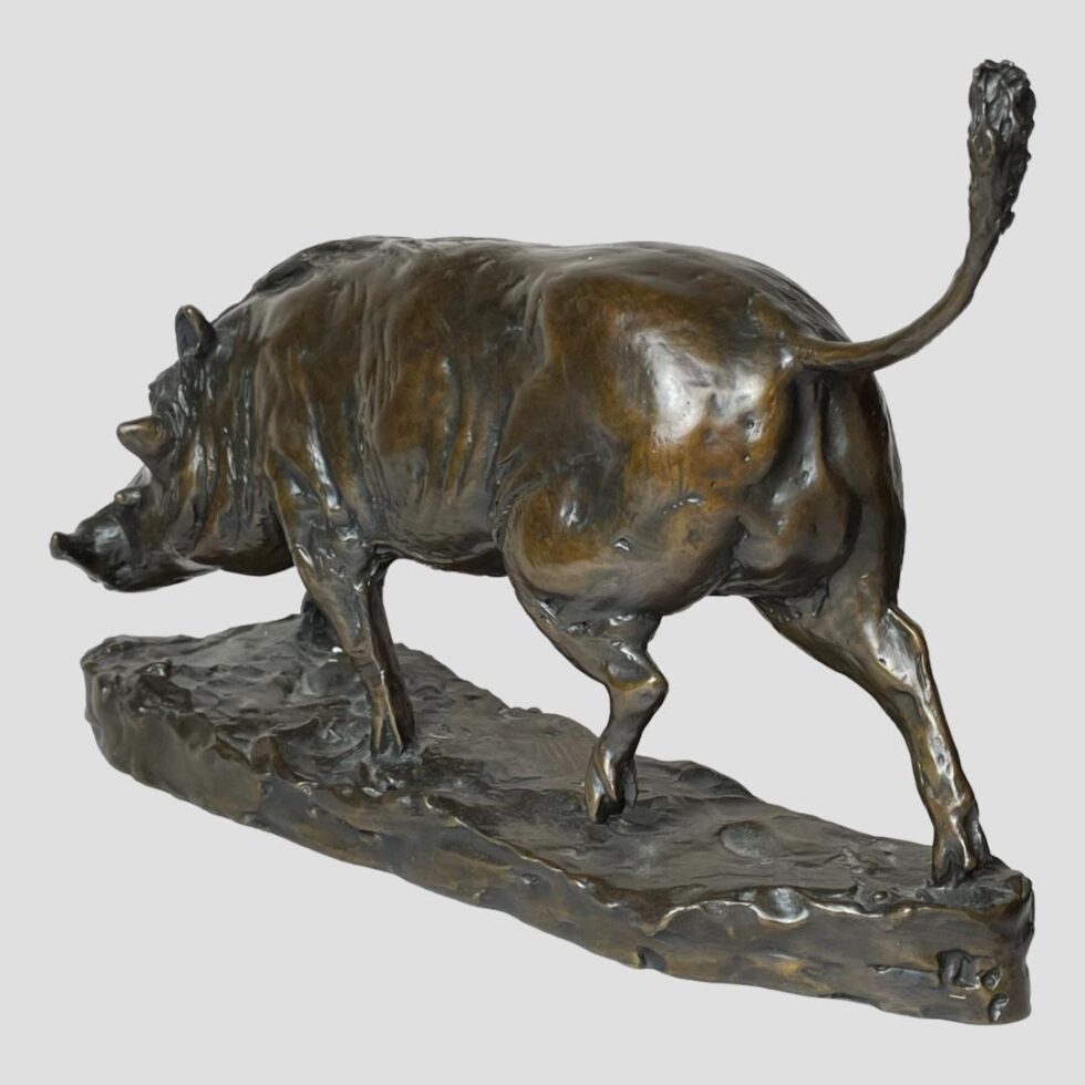 Photo of Harriet Glen bronze boar this time facing to the top left corner. The back end of the boar is in the foreground and to the bottom right.