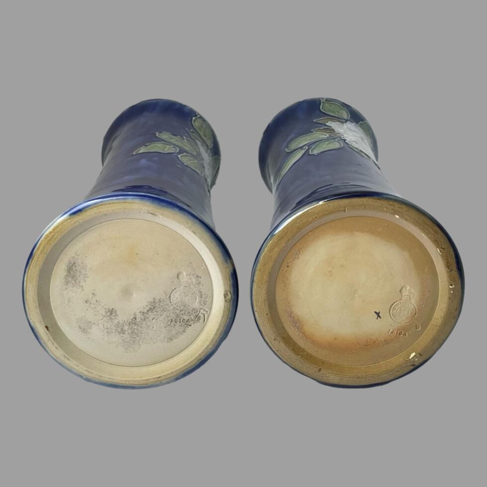 Photo of the base of both vases showing the debossed Royal Doulton stamp to the right of each.
