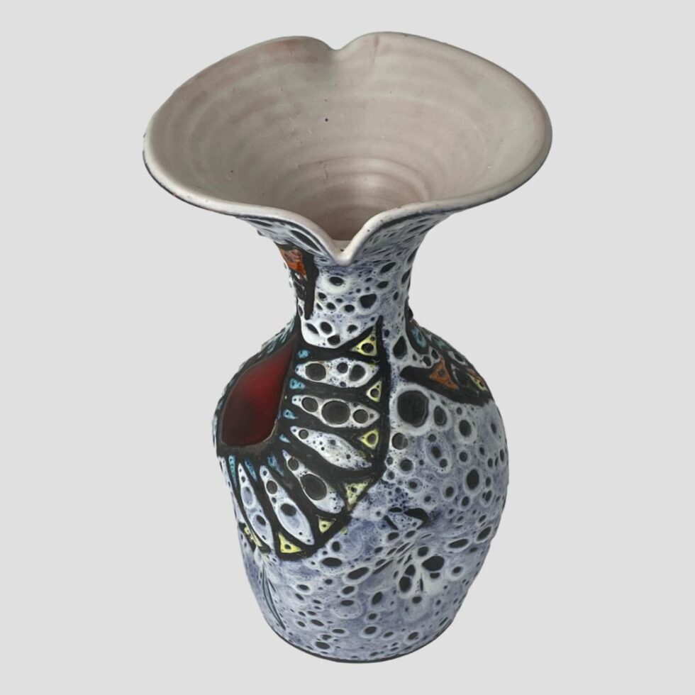 Photo of Vallauris vase seen from a side angle and raised so the spouts are in top centre and mid centre. There is a lovely fluid design.