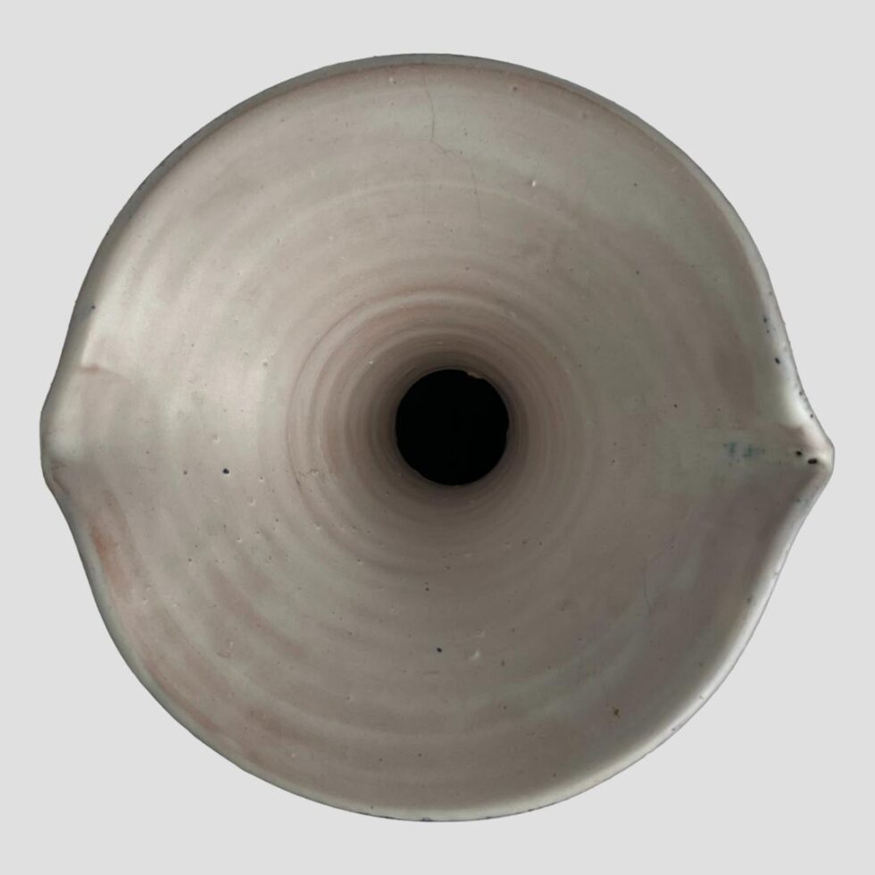 Photo looking straight down at the top of the vase with the spouts on the left and right.