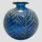 Main photo of signed Mdina ball vase seen from an eye level. The stunning lagoon blue vase has light golden palm like fronds shimmering over the top and all around giving a feeling of tropical paradise. The fabulous large ball shaped vase is finished with a modest lip at the top.
