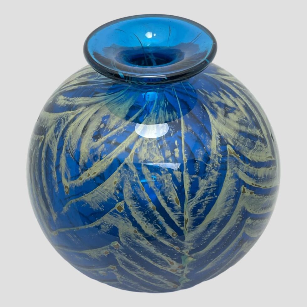 Mdina ball vase seen from a slightly raised angle looking diagonally down at the top. The light is bouncing off the blue like reflections in water.