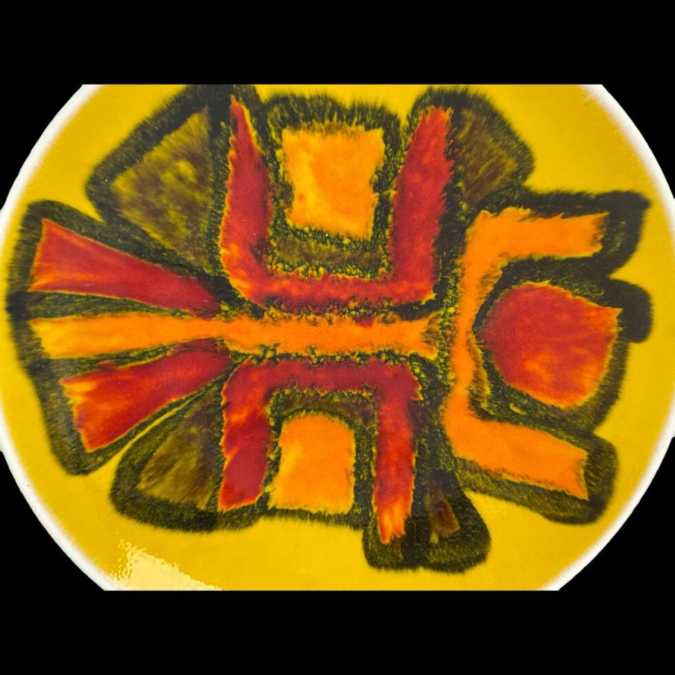 Close up photo of the colourful design centre of the Poole yellow Delphis dish.