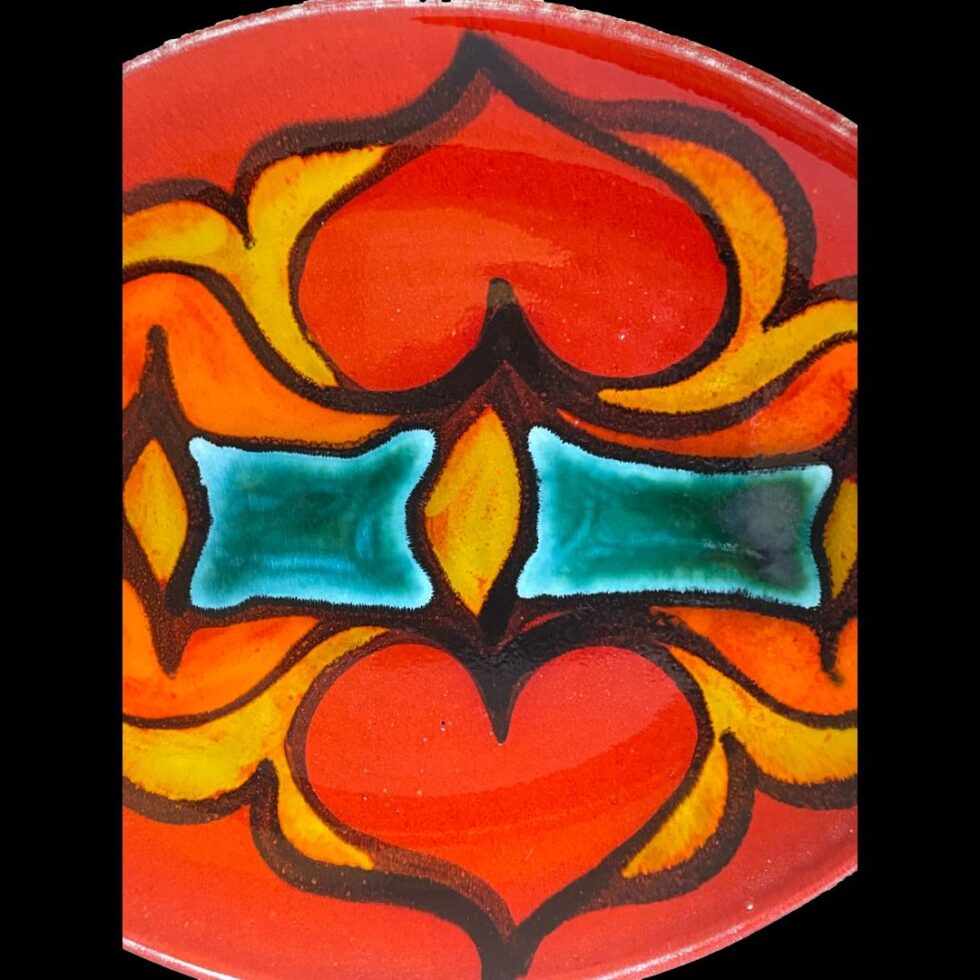 Close up photo of the vibrant decoration in the centre of the red Poole Delphis dish.