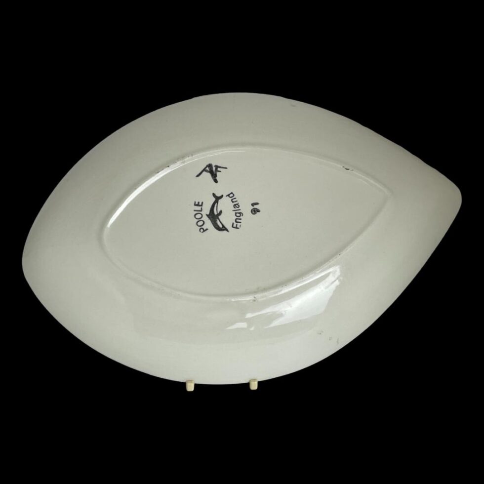 Photo of the back of Poole red Delphis dish showing the Poole stamp on the base.