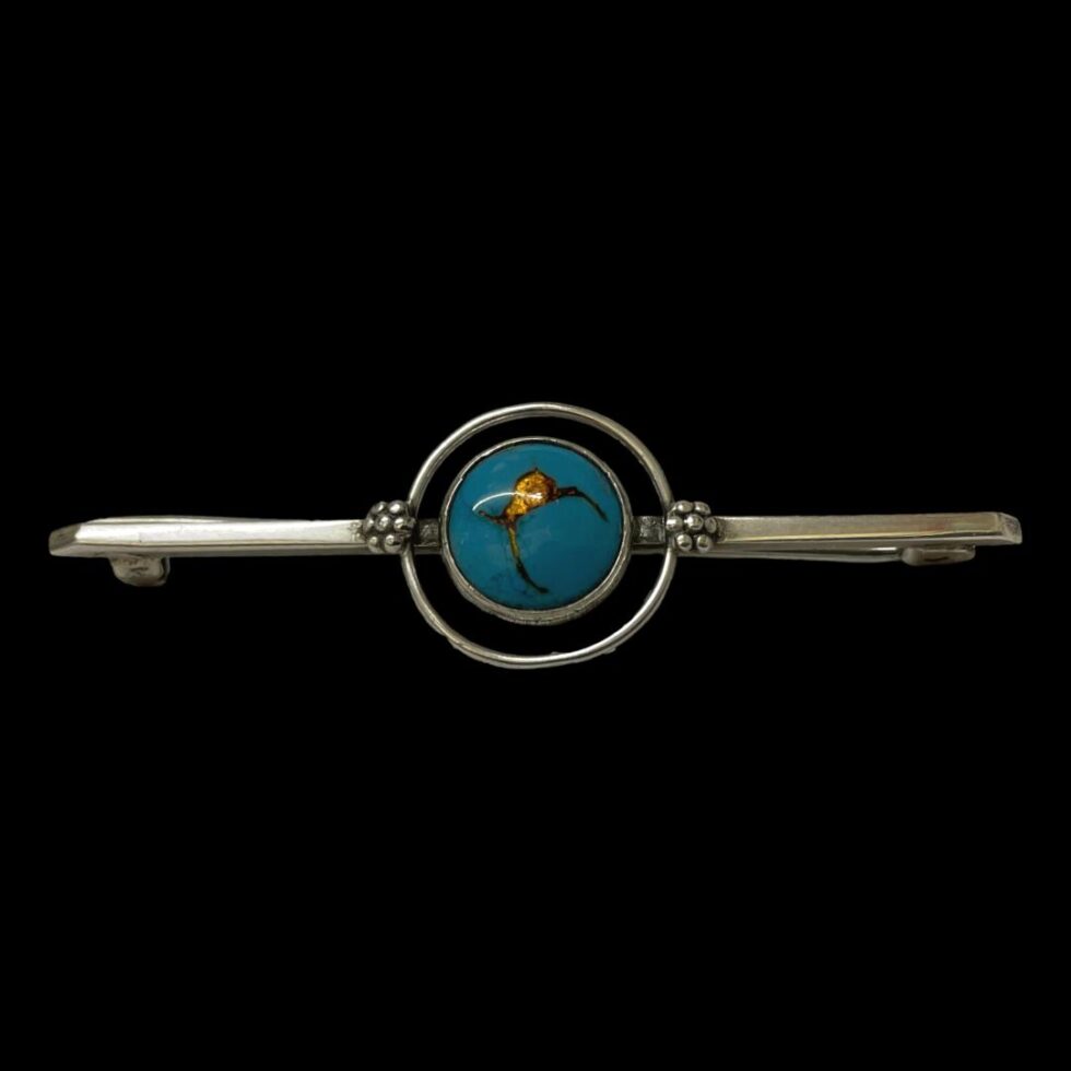 Photo zooming out of the centre blue enamel to see the whole brooch in its entirety