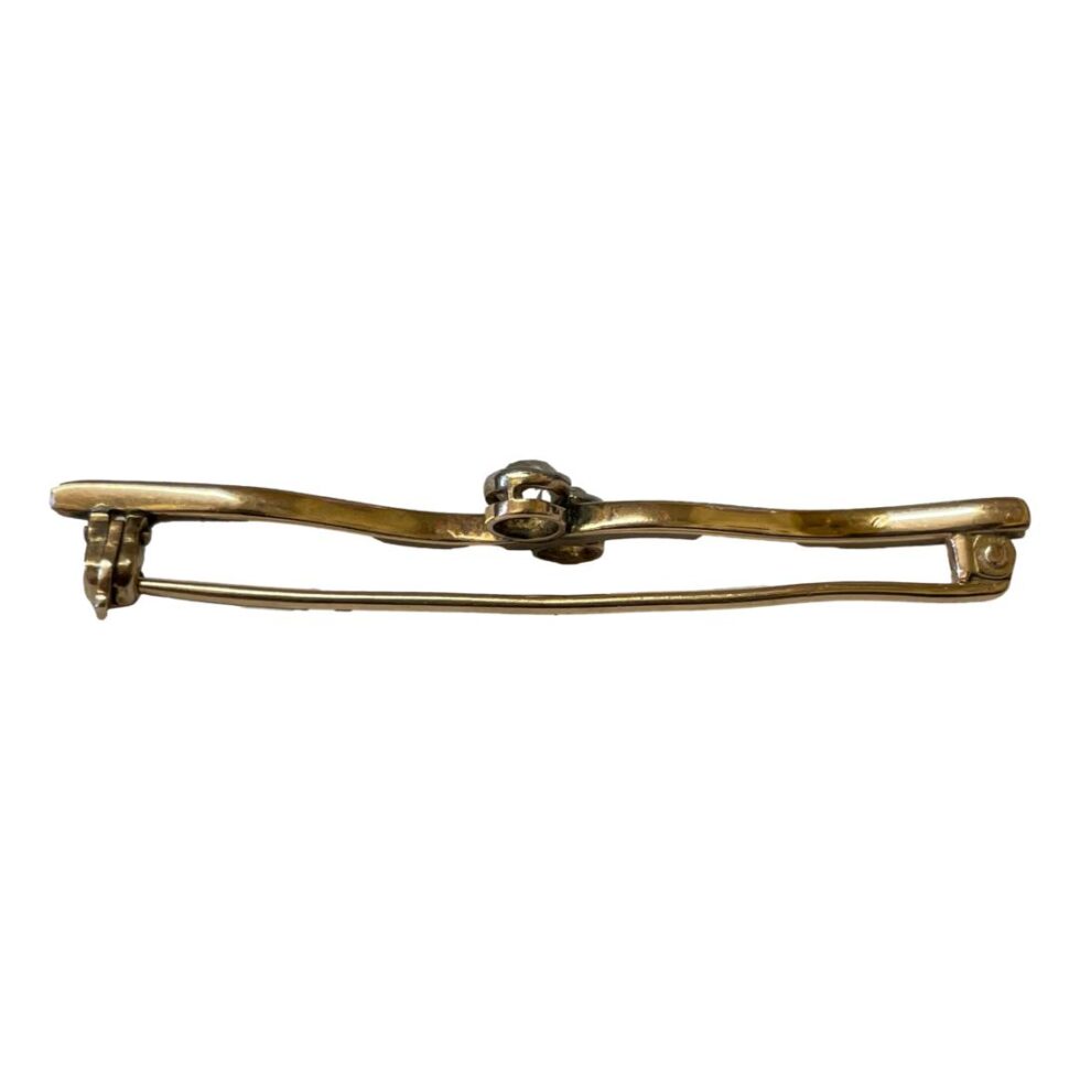 Photo looking down at the Edwardian gold diamond brooch from above so the brooch front is at top and pin below - a cross section photo.