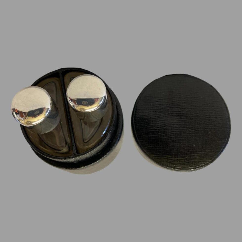 Photo of the silver topped half bottles displayed inside their fitted compartments inside the case. We are looking straight down from the top. The lid for the case is on the right.