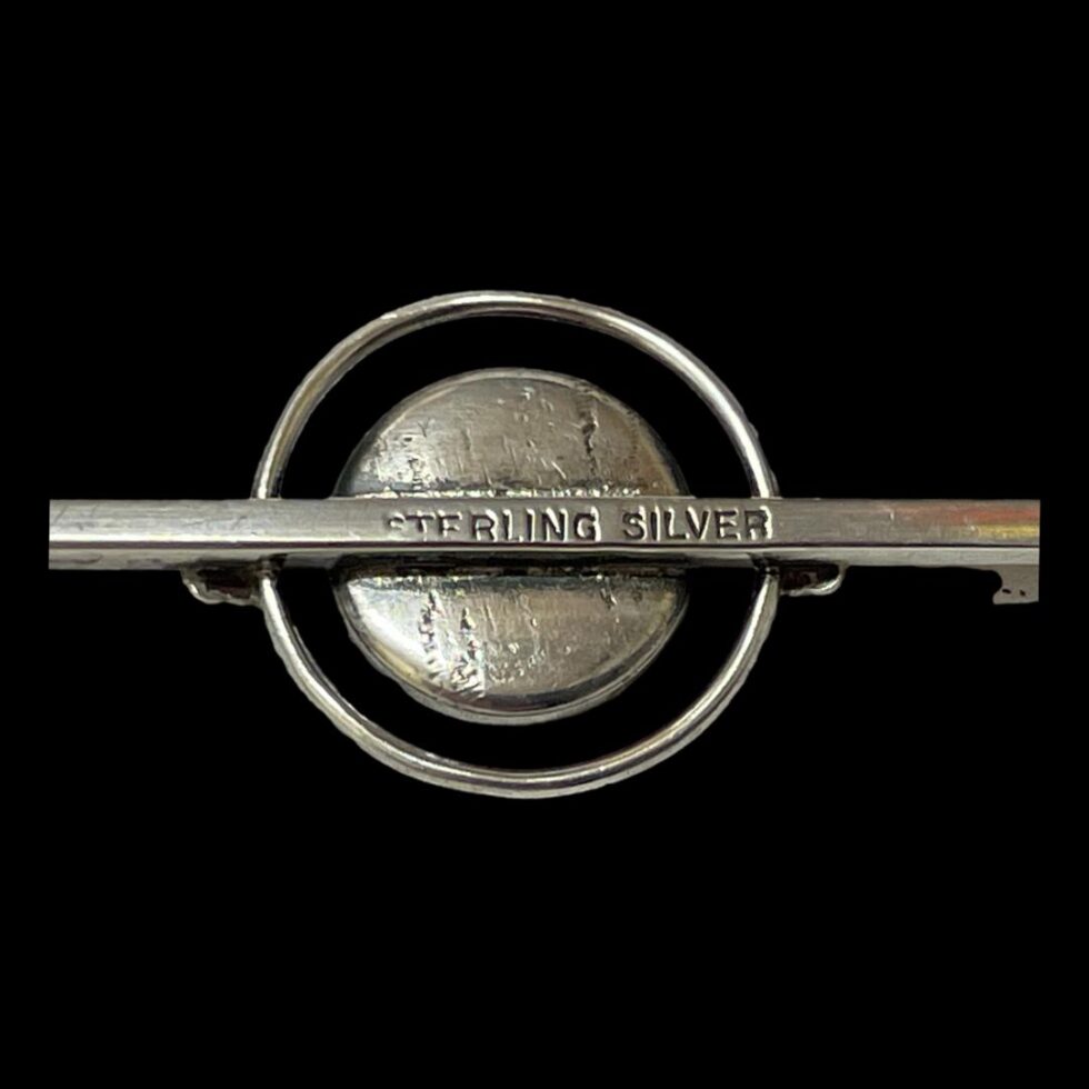 Close up photo of the sterling silver hallmark to the back of brooch bar.