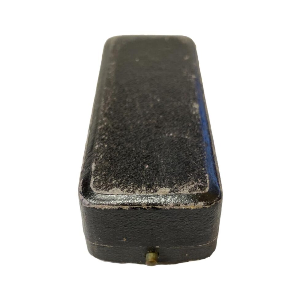 Photo of the original case for the gold heart stick pin showing signs of wear.