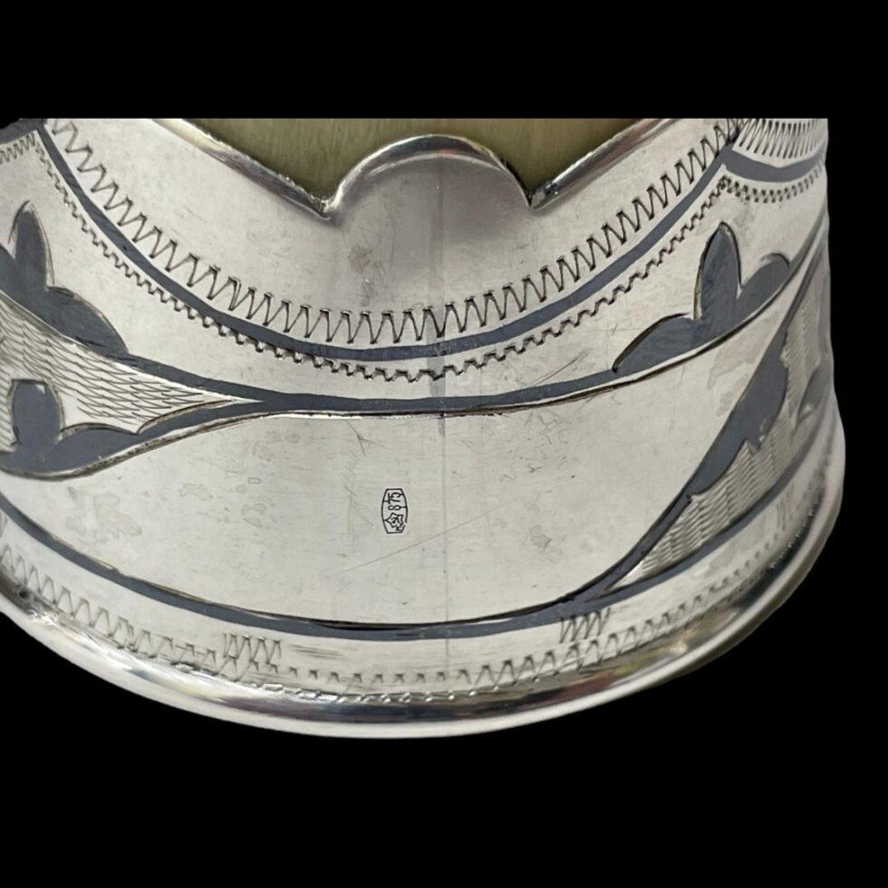 A close up photo of the 875 hallmark on the rim of the vessel mouth.