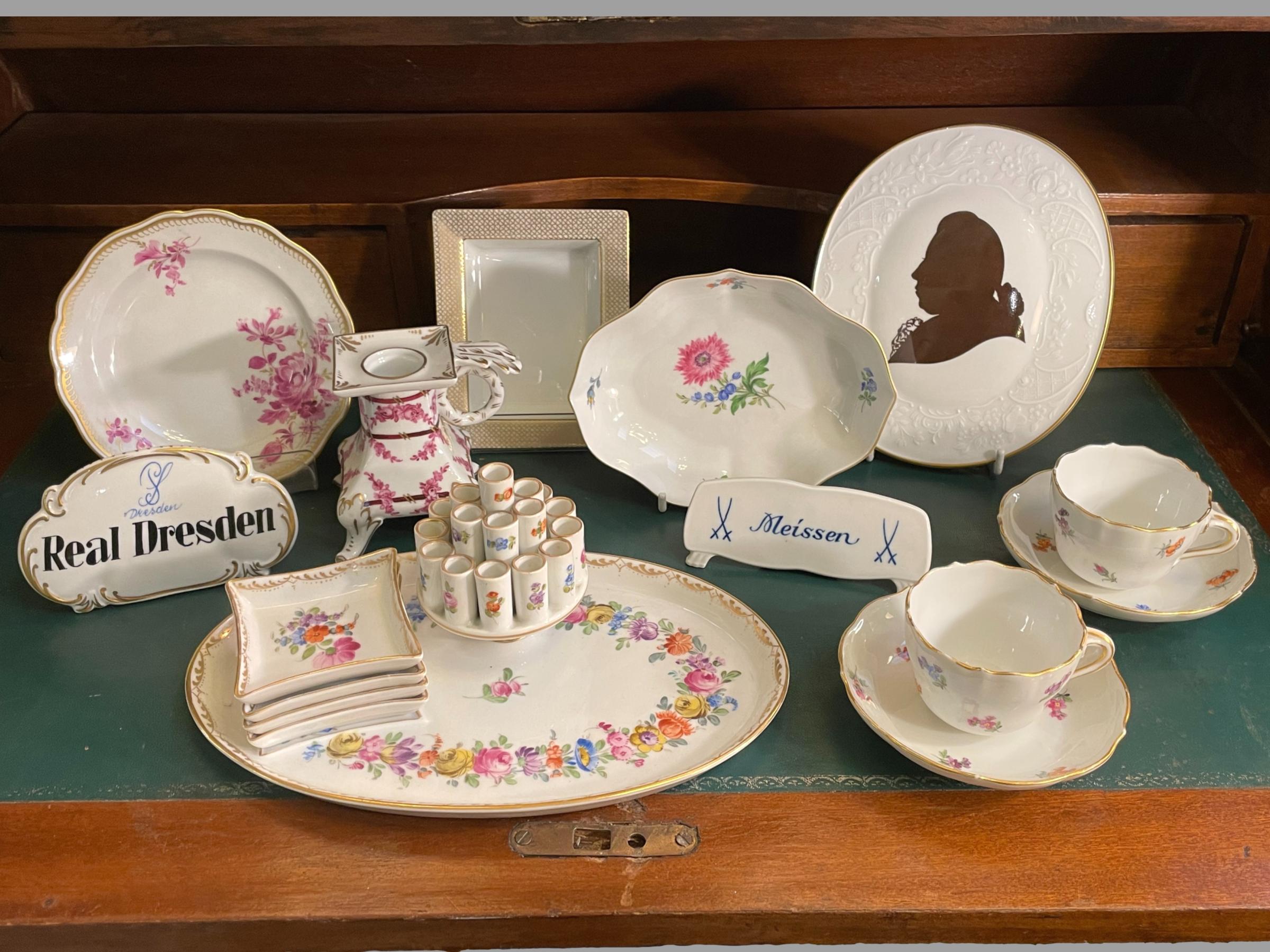 Perfect Porcelain Main photo showing a selection of Dresden and Meissen porcelain displayed on top of an antique desk.