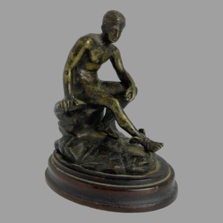 Main photo of Grand Tour Hermes bronze displayed with the forward placed right leg pointing to the bottom right corner. His left arm rests on his leg leg and he looks in deep thought. The bronze has an interesting patina with a slightly green tinge to the bronze which adds character to the piece. A fabulous miniature bronze for the discerning collector.