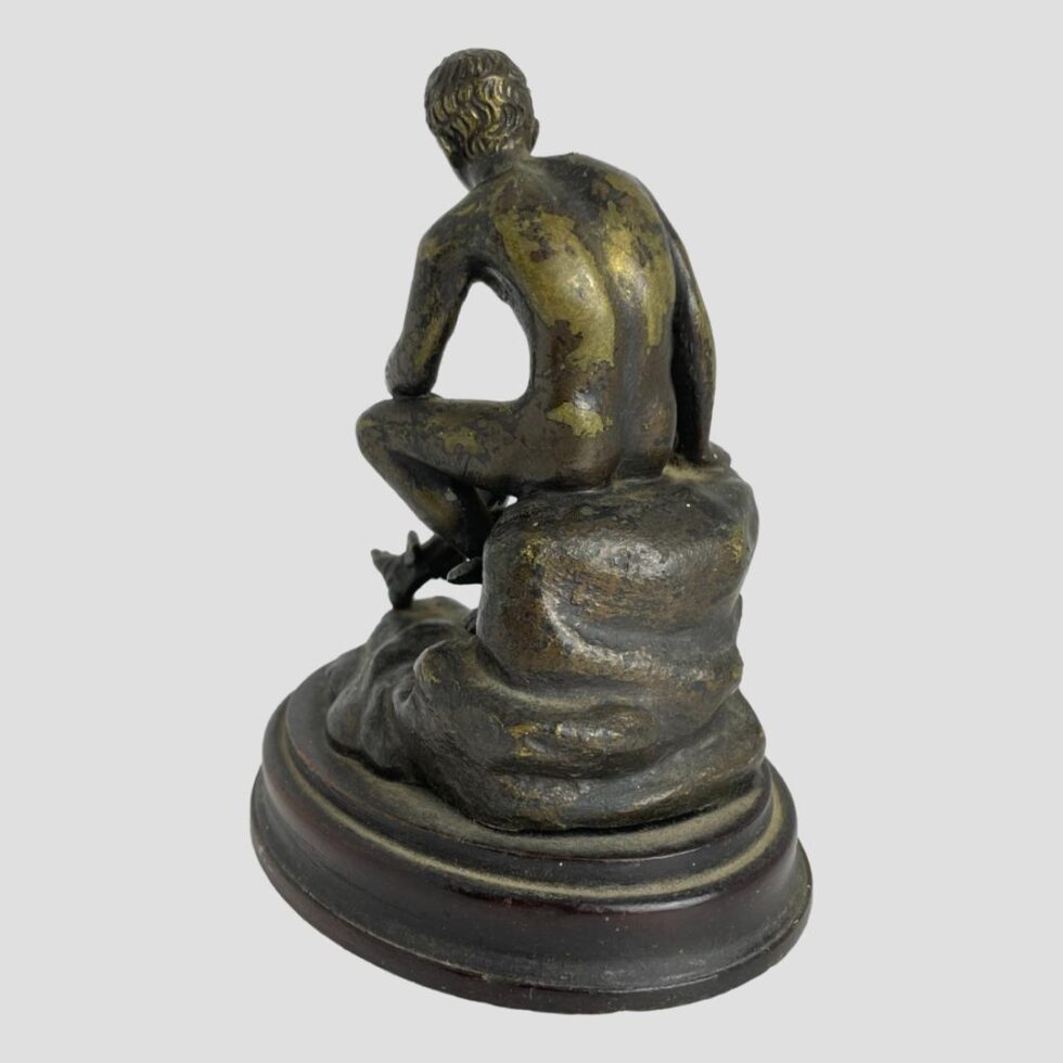 Photo of the back of Hermes. This time he is facing the top left corner with bare back on display.